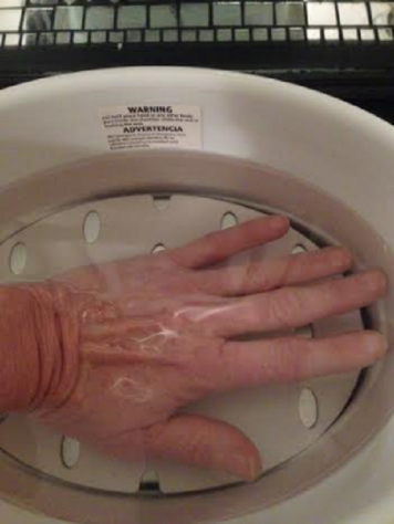Dipping hand in wax bath